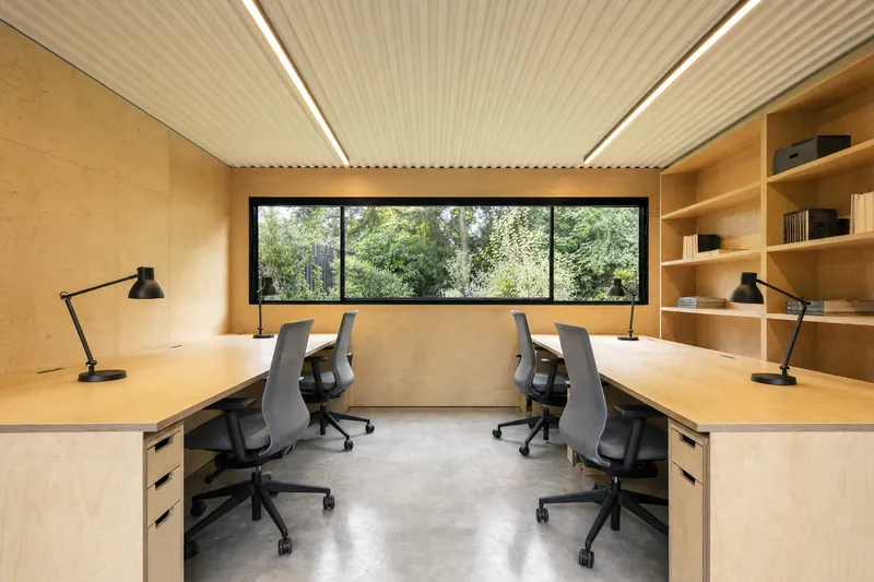 Escritório modular com quatro postos de trabalho em bancadas de contraplacado